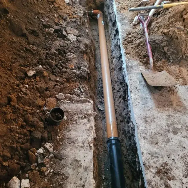 New drainage pipework laid in an excavated trench