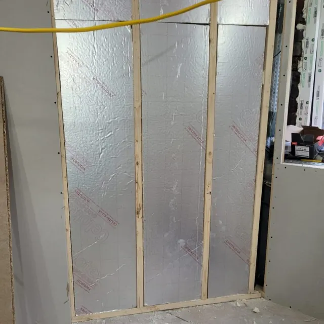Insulation boards fixed between timber battens before plasterboarding